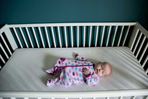 newborn in a crib
