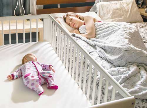 Baby crib next to parents bed best sale